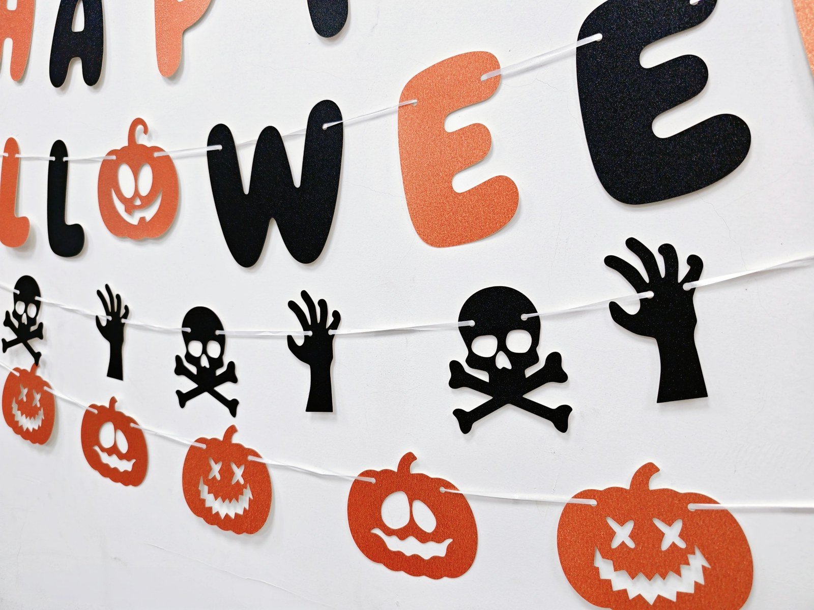 Halloween glitter letter banner with orange and black letters, pumpkins and skeletons — additional view