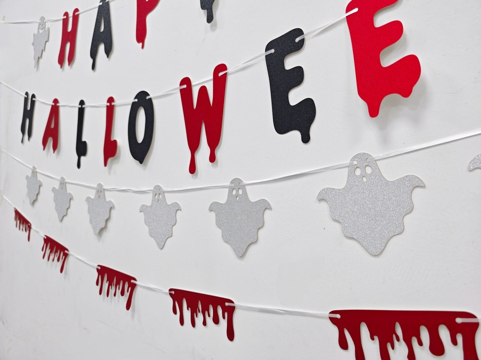 Halloween glitter letter banner with red and black letters, silver ghosts and red drip shapes — additional view