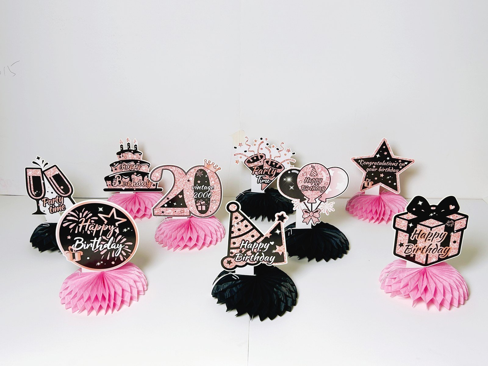 20th birthday pink honeycomb table decorations with nine black and pink pieces — additional view