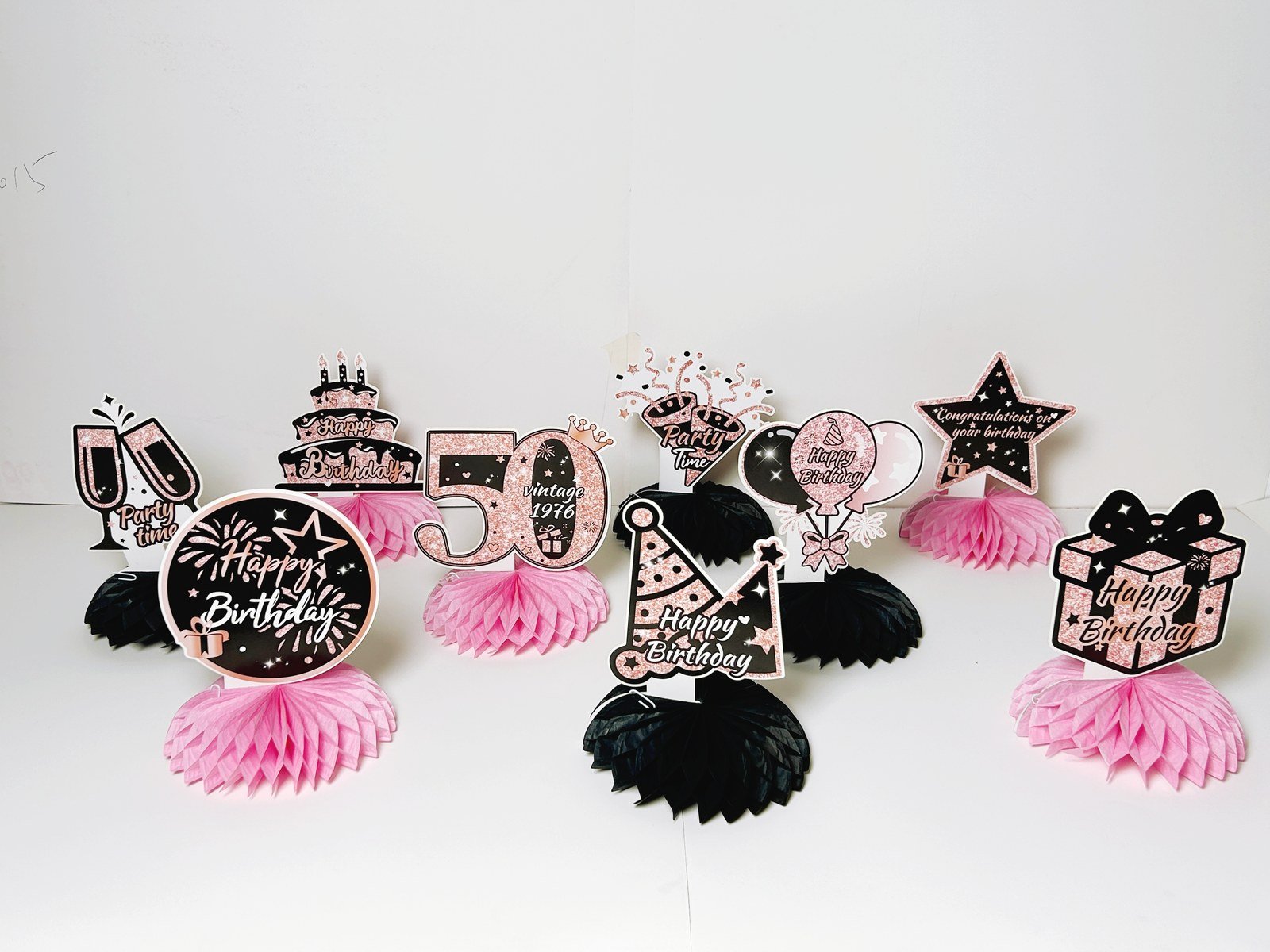 50th birthday pink honeycomb table decorations with nine black and pink pieces — additional view