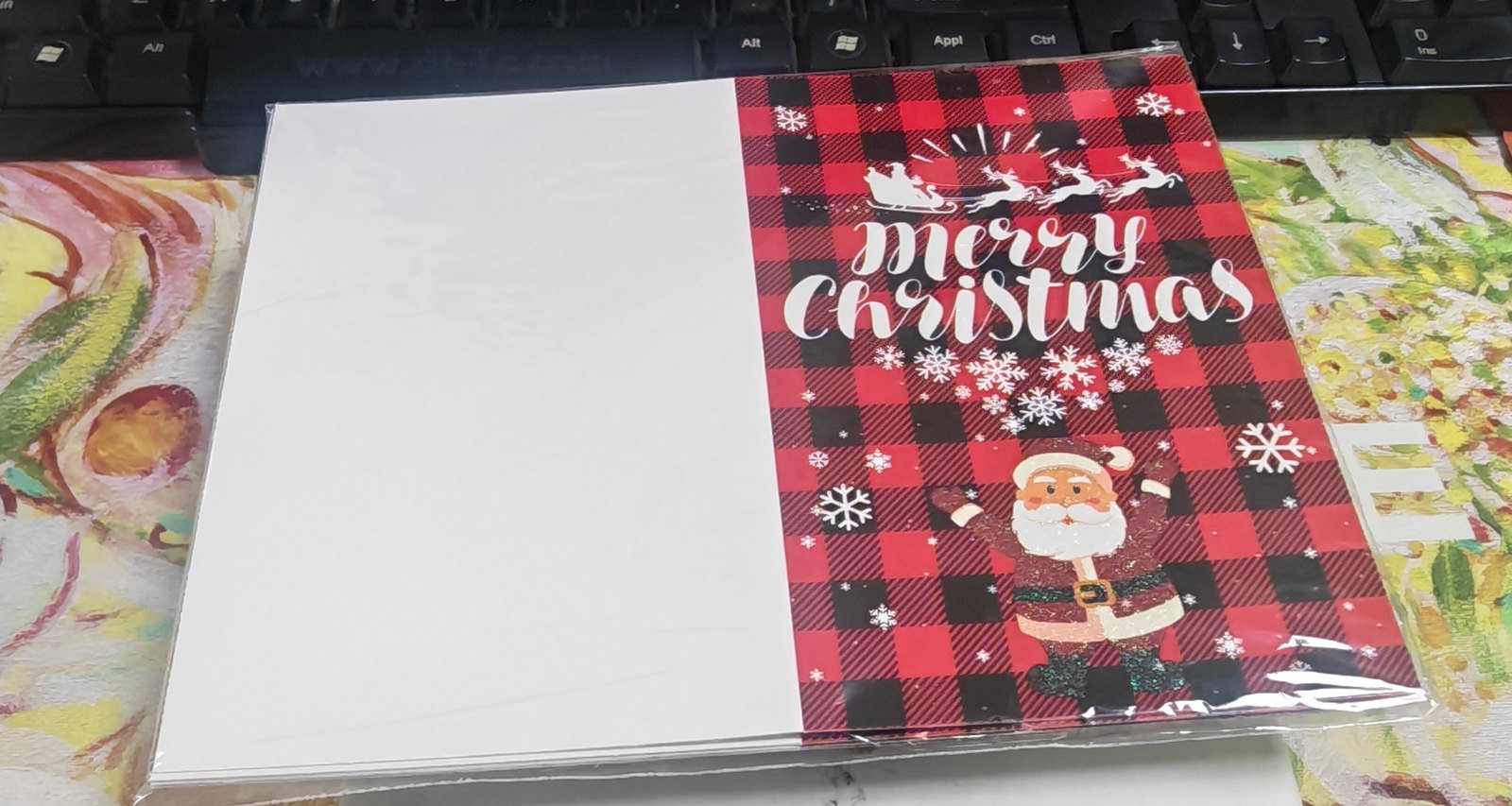 Christmas greeting cards set A2 — red and black buffalo-plaid Merry Christmas card with Santa and snowflake design in a protective sleeve